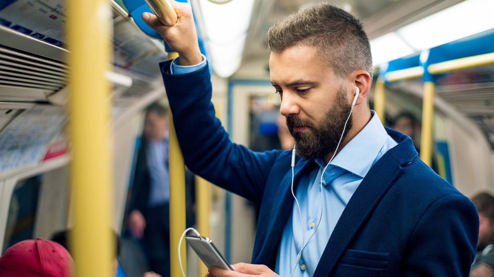 Man on subway using e-learning platform on mobile device phone